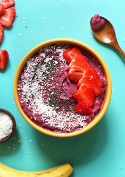 Berry smoothie bowl with strawberry on top 