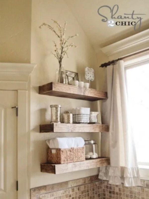 Rustic Bathroom Shelves With Towels and A Window Beside it