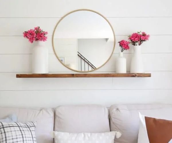 Floating Shelves With Mirror and Pots of Flowers