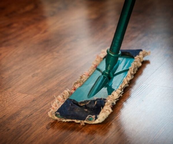 A mop on a wooden floor.